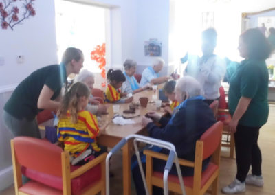 Woodstock residents making clay crafts with children from Squirrel Nursery