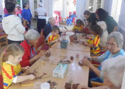 Woodstock residents and the children from Squirrel Nursery making clay crafts together