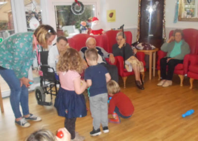 Young children from Rodmersham Nursery playing with residents from Woodstock Residential Care Home