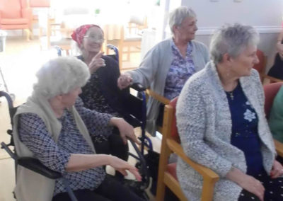 Woodstock resident residents dancing in their chairs to the Michel Bublé act