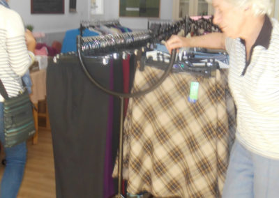 One of the ladies at Woodstock looking through Gemini Clothing's rails
