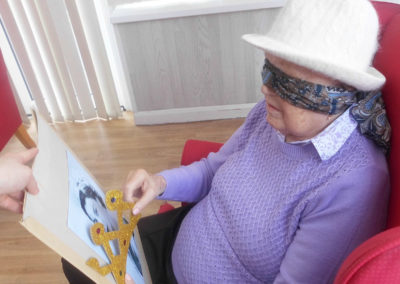 Blindfolded Woodstock resident attempting to pin a crown on a picture of the Queen