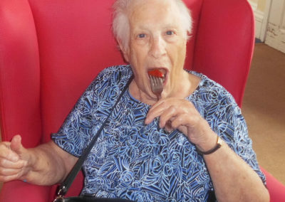 Lady resident eating a fresh strawberry