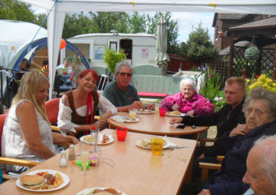 Family and friends around a table at the Woodstock pirate-themed barbecue