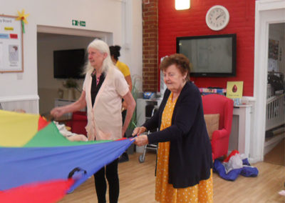 Residents at Woodstock playing parachute games together