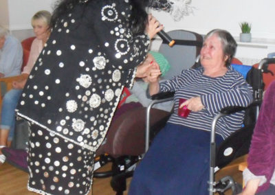 Pearly Queen Annie singing to a resident at Woodstock Residential Care Home
