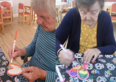 Residents colouring wind chimes at Woodstock