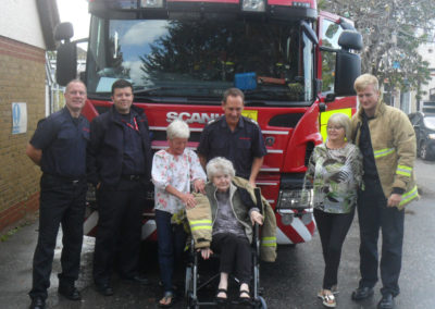 Sittingbourne fire crew with Woodstock resident by their fire engine