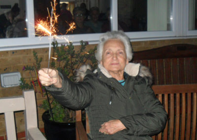 Lady resident in the garden with a sparkler