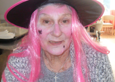 Lady resident in witches hat and face paints