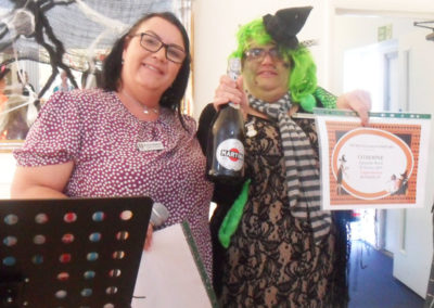 Staff receiving prize for her witches outfit