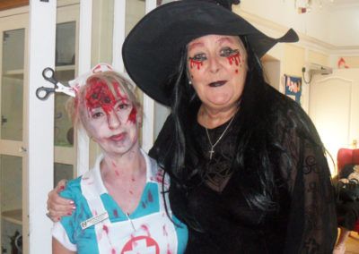Staff member dressed up as a Halloween nurse and witch