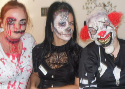 Staff members wearing Halloween costumes and face paints