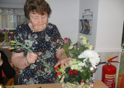 Making festive table flower decorations at Woodstock Residential Care Home