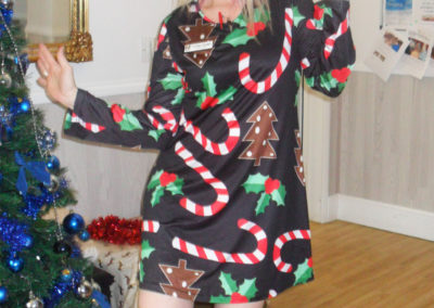 Woodstock Residential Care Home staff member dressed in a candy cane Christmas dress