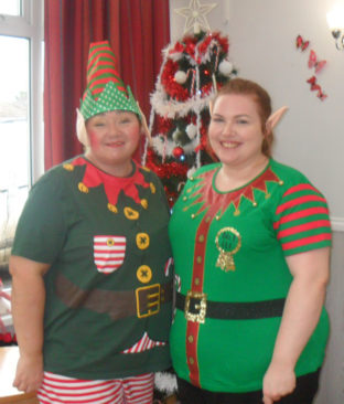 Two Woodstock staff dressed as Christmas elves