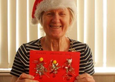 Woodstock resident holding up her handmade Christmas card