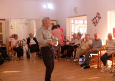 Residents and staff in their lounge during a Music for Health workshop