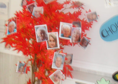 A red tree decorated with residents' individual photos