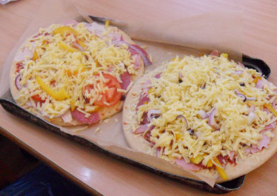 Two hand made pizzas covered with cheese