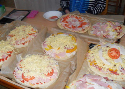 A table with a batch of handmade pizzas ready to cook