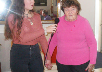 Singer Isobel with a resident up with the microphone