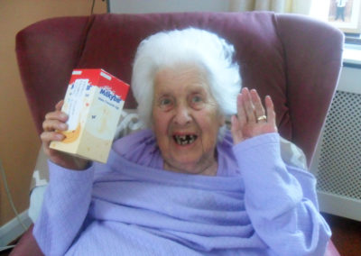 Lady resident at Woodstock Residential Care Home with her Easter egg