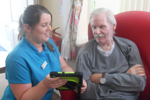Male resident and Woodstock Care Home staff member using interactiveMe