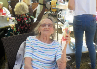 Woodstock Residential Care Home resident in the garden holding a sweetie cone