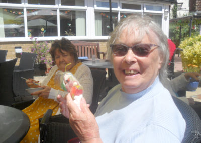 Woodstock Residential Care Home resident with a sweetie cone, smiling at the camera
