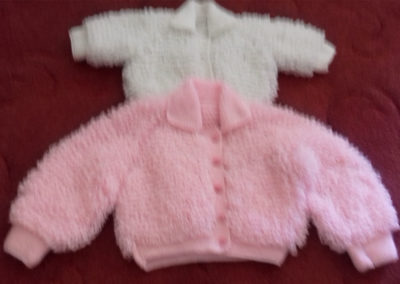 Two knitted baby jackets