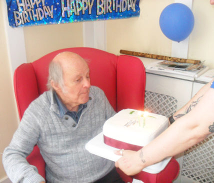 Woodstock Residential Care Home resident receiving an iced birthday cake