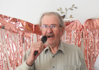 Gentleman singing with a microphone at Woodstock Residential Care Home