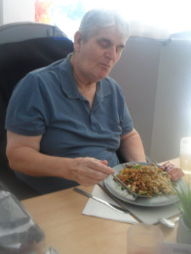 Resident at Woodstock Residential Care Home eating a Chinese meal