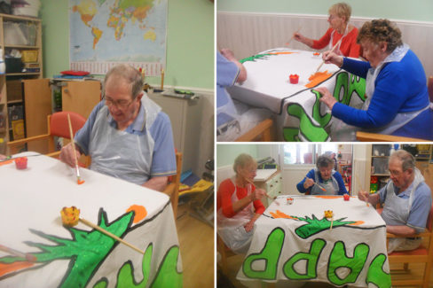 Residents painting a Halloween banner