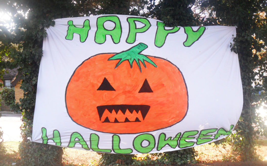 Woodstock Residential Care Home residents paint Happy Halloween banner