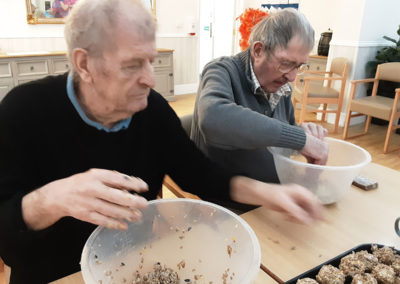 Woodstock Residential Care Home gents mixing fat ball bird feeders