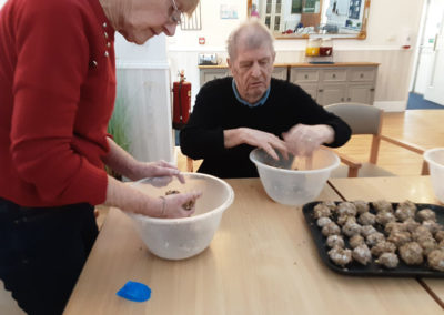 Woodstock Residential Care Home residents combining fat ball ingredients to make bird feeders