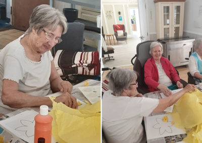 Residents making daffodils at Woodstock Residential Care Home