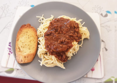 Delicious spaghetti bolognese with garlic bread made at Woodstock Residential Care Home