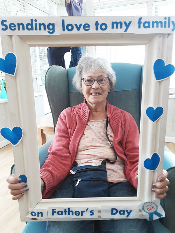 Woodstock Residential Care Home residents with a themed Father's Day photo frame
