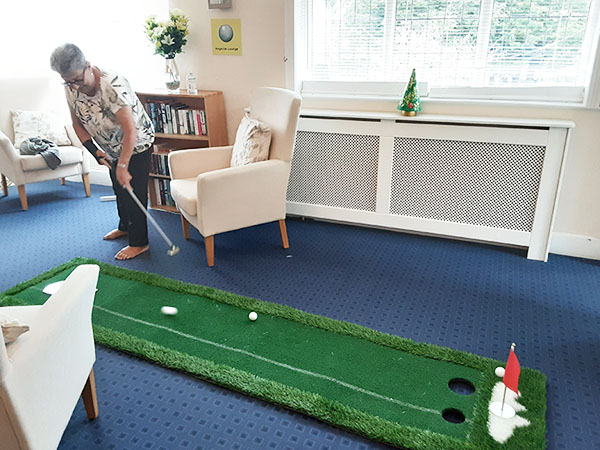 Woodstock Residential Care Home resident taking a crazy golf put