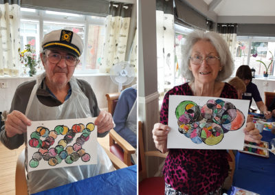 Woodstock Residential Care Home residents showing off their abstract paintings
