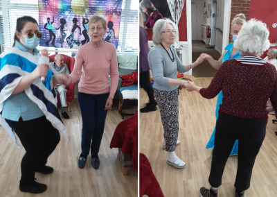 Residents and staff dancing at an ABBA party at Woodstock Residential Care Home