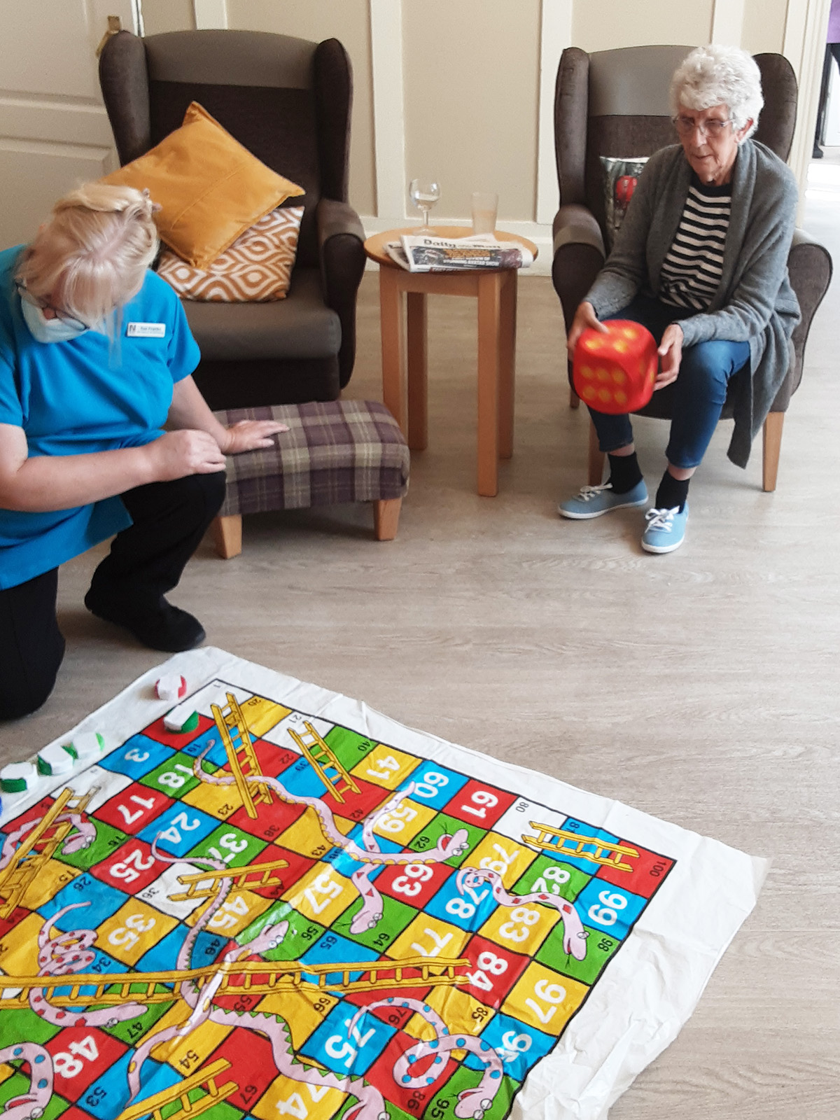 Woodstock Residential Care Home resident rolling a dice for floor snakes and ladders