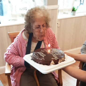 Jean with her birthday cake at Woodstock Residential Care Home