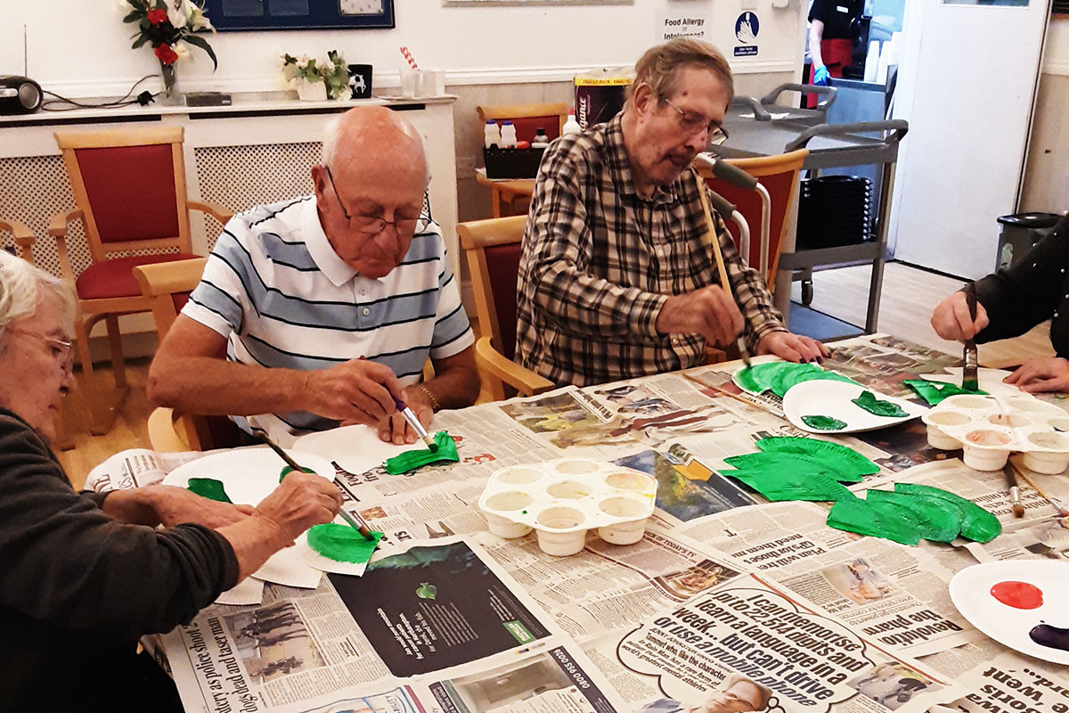 Woodstock Residential Care Home residents painting Christmas tree decorations